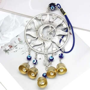 Detail of sun and moon镂空 metal disc with blue evil eye beads and golden bells charms