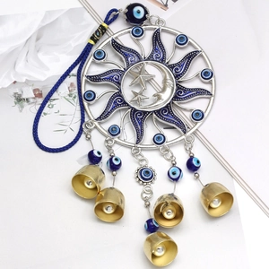 Detailed macro view of celestial sun moon wind chime with blue evil eye beads and bells