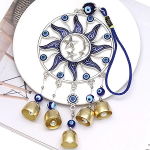 Celestial sun and moon gold bell pendant with evil eye beads and blue hanging cord