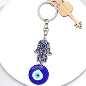 Silver Hamsa Hand keychain with blue rhinestones and Evil Eye glass charm for car or bag