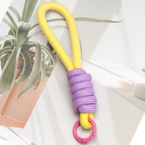 Close-up of DIY woven key chain pendant with colorful rope and pink metal spring buckle