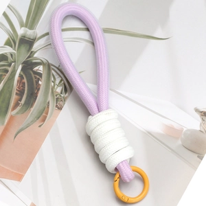 Detail of purple and white braided lanyard with a vibrant yellow circular spring buckle