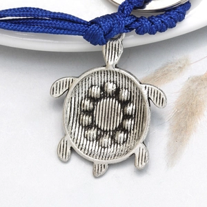 Retro silver turtle evil eye keychain with deep blue woven rope and detailed carving