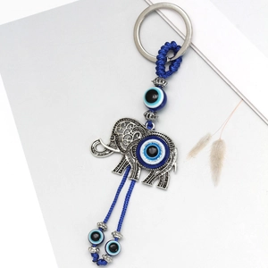 Detail of evil eye elephant keychain with blue braided rope and silver metal finish