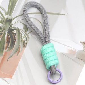 Detail of grey braided lanyard with mint green accents and purple spring ring clasp