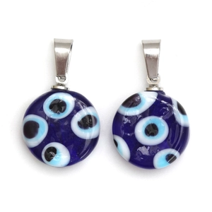 Détail de pendentifs œil bleu en verre avec bélières en métal argenté et texture verre