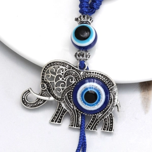 Detailed close-up of elephant evil eye charm with intricate silver carvings and blue beads