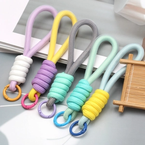 Macro shot of colorful U-shaped woven lanyards with spring rings and braided textures