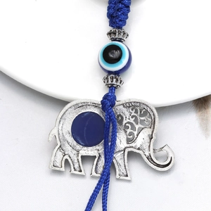 Detailed close-up of a silver elephant evil eye charm with intricate vintage engraving