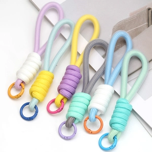 Set of six colorful macaron braided rope keychains with spring snap hooks on magazine