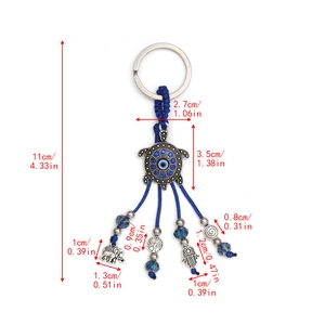 Detail of evil eye turtle keychain with elephant, tree of life and hand pendants