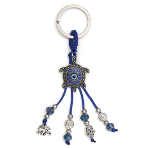 Detailed view of turtle evil eye keychain with hamsa hand and elephant charms