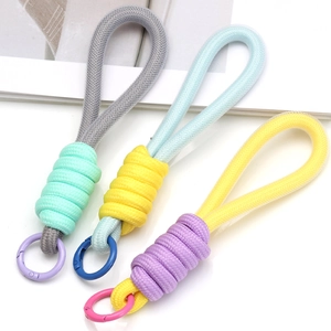 Detailed view of handmade braided phone charms with colorful metal rings in three colors