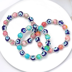 Detailed view of evil eye bracelet set featuring blue beads and rhinestone spacers
