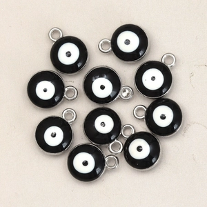Detailed close-up of ten DIY silver alloy evil eye pendants for jewelry making