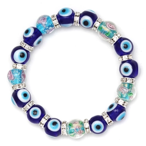 Close-up of blue evil eye beads and floral glass beads with sparkling rhinestone spacers