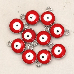 Macro shot of red evil eye charms with silver alloy edges and double-sided oil drop detail
