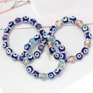Three-piece Evil Eye beaded bracelet set with blue glass charms and rhinestone spacers