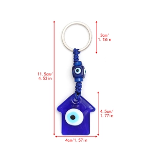 Detailed view of evil eye keychain featuring blue woven cord and house shaped pendant