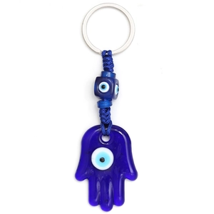 Detail of Hamsa Hand and Evil Eye glass pendants on a blue woven keychain cord