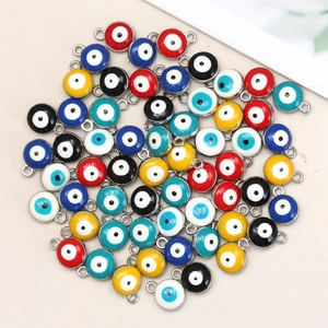 Macro shot of colorful enamel evil eye charms with silver metal borders for DIY jewelry