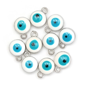 Macro detail of silver plated evil eye charms with blue enamel for DIY jewelry making