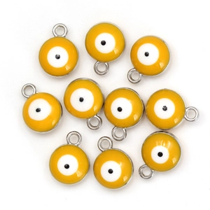 Detail view of ten yellow evil eye charms with silver borders for DIY jewelry making