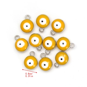 Detailed view of ten 8mm yellow evil eye charms with silver plating for DIY necklaces