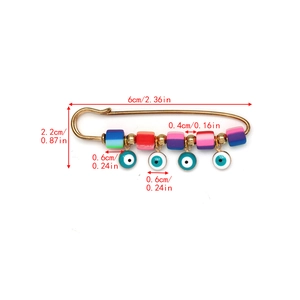 Detailed view of evil eye safety pin brooch with colored beads and measurements