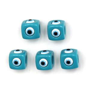 Macro shot of turquoise cube beads with evil eye pattern for DIY jewelry making
