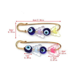 Detail view of Evil Eye safety pin brooches with colorful resin butterflies and size dimensions