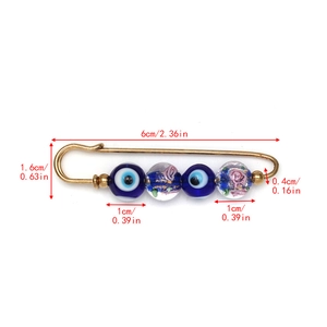 Detailed size view of Evil Eye brooch with blue and floral beads on 6cm gold safety pin