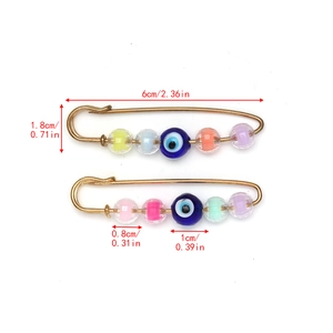 Detailed size view of evil eye safety pins with colorful candy beads in gold metal