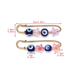 Detailed view of Turkish Evil Eye star brooches with measurement specs on white background