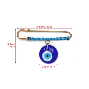 Detailed view of evil eye brooch with size measurements and blue glass charm