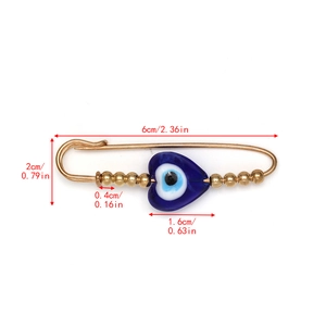 Macro view of evil eye safety pin brooch showing dimensions 6cm length and 2cm height