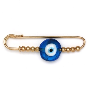 Detailed view of golden safety pin brooch featuring blue evil eye bead and gold round beads