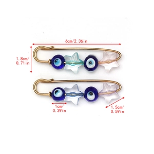 Detail view of Evil Eye safety pin brooches with star charms and blue beads, 6cm length