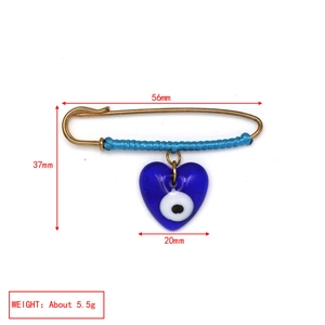 Detail showing dimensions and 5.5g weight of a blue Evil Eye heart safety pin brooch
