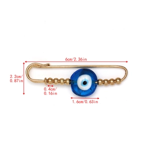 Detailed view of evil eye pin dimensions showing 6cm length and blue glass bead textures