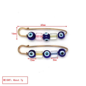 Detailed view of evil eye safety pin brooch with measurements and weight specifications