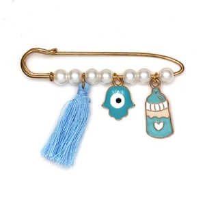 Détail de la broche épingle à nourrice pour bébé avec œil bleu et main de hamsa