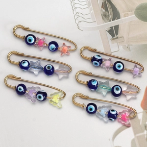 Set of 6 gold pins with blue evil eye beads and colorful star charms for clothing