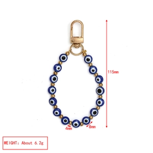 Detailed view showing Evil Eye charm dimensions and lobster clasp in golden finish