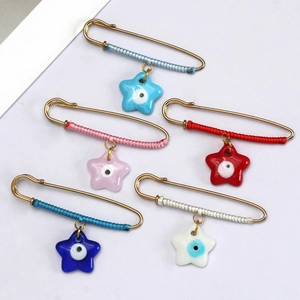 Set of five colorful evil eye star pins with woven thread and gold finish accents