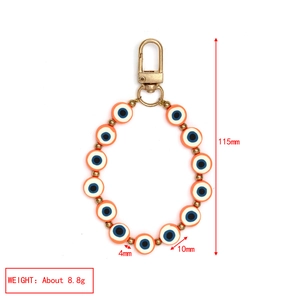 Detail of orange Evil Eye beaded charm with dimensions 115mm length and 10mm bead size