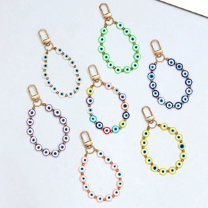 Macro detail of assorted colorful evil eye bead charms with secure gold lobster clasps