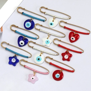 Detailed set of 10 golden evil eye safety pins with colorful threads and assorted charms
