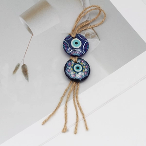 Ethnic blue evil eye tassel charm with natural jute rope and mandala painted beads