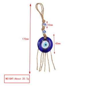 Detailed view of Evil Eye charm with blue glass, ceramic beads and jute rope tassels